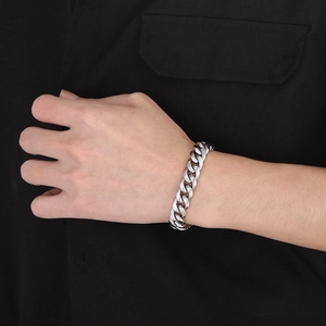 Close-up of high-polished silver stainless steel Cuban link bracelet on male wrist