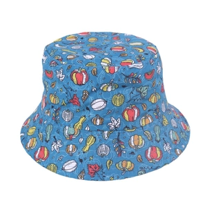 Detailed close-up of blue kids sun hat with pumpkin and autumn leaf cartoon prints