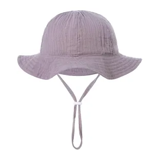 Detailed close-up of purple cotton baby sun hat with textured fabric and adjustable chin strap