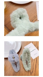 Close-up of green and grey plush large hair claw clips showing soft fuzzy texture