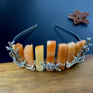 Detail of orange natural crystal headband with silver moon star and branch accents