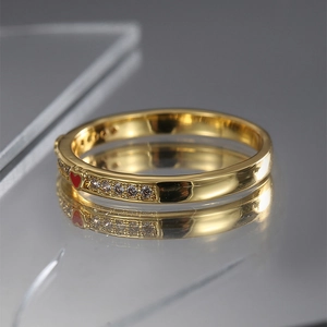 Elegant gold-plated heart ring with red enamel and pavé zircon stones on mirror surface