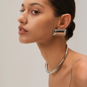Minimalist silver geometric earrings and smooth metal choker necklace set on model