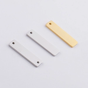 Close-up of polished gold and silver rectangular stainless steel blank charms for DIY jewelry