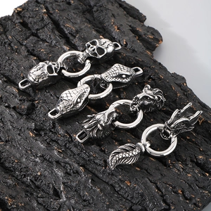 Gothic punk style stainless steel serpent and skull spring clasps on dark wood base