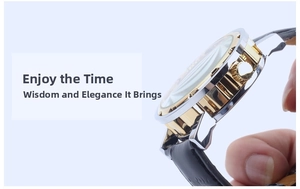 Close-up of polished silver and gold watch case with leather strap and crown detail