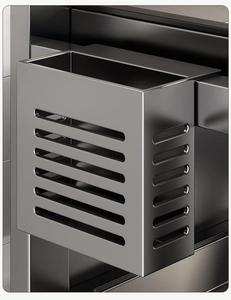 Close-up of stainless steel utensil holder with ventilation holes and drainage base