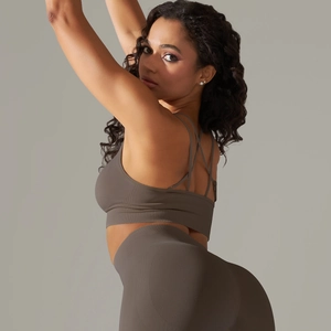 Detail of cross back straps and seamless ribbed texture on dark grey sports bra set