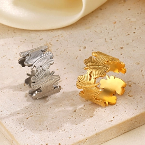 Adjustable leaf rings in gold and silver finish with matte brushed stainless steel texture