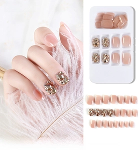 Detail of nude pink gradient press-on nails with 3D rhinestones and 24-piece full set layout