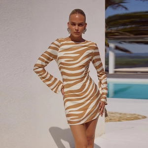 Outdoor street style view of zebra print long sleeve mini dress in brown and white