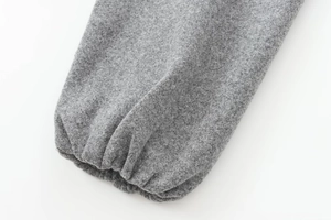 Close-up of the grey bomber jacket elastic cuff showing soft thick wool fabric texture