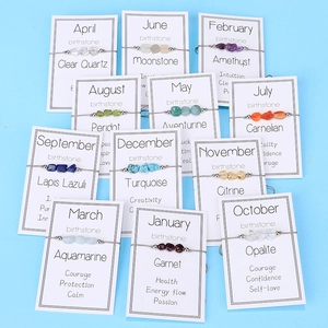 Irregular raw gemstone birthstone bracelets set on white cards with 12 months display
