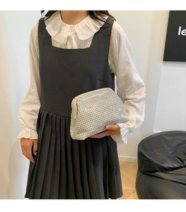 Detailed view of luxury shell-shaped evening bag with silver rhinestones on the side
