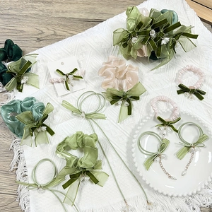 Elegant lily of the valley hair tie set with green silk scrunchies and bow clips