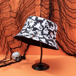 Close-up of Halloween bucket hat with white ghost prints on orange background