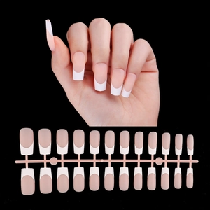 French tip press-on nails set with pink base and white tips on a black background