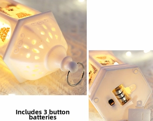 Detail of white Christmas lantern base with three button batteries and power switch