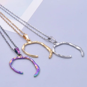U-shaped stainless steel necklaces in gold, silver, and neon finishes on purple background
