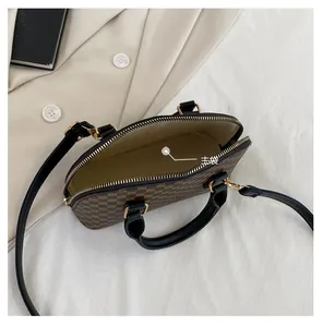 Detail view of the main pocket interior and classic monogram pattern on the shell bag