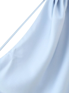 Detail of light blue satin fabric texture and slender strap on the summer halter dress