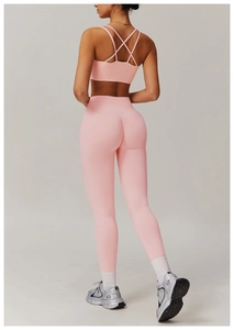 Pink quick-dry yoga set featuring criss-cross back sports bra and seamless scrunch leggings