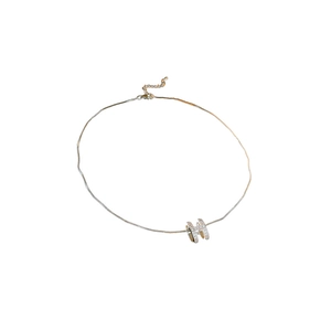 Silver H-letter necklace with pave-set zircons on an adjustable chain over white background