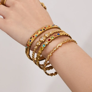 Luxurious gold stainless steel bangle set with 5A zircons and colorful gemstones on wrist