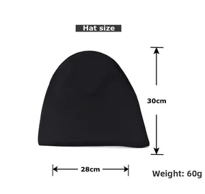 Flat lay of black knit beanie with size markings 28cm width and 30cm height
