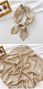 Detail of khaki silk scarf with white cross grid pattern and smooth satin texture