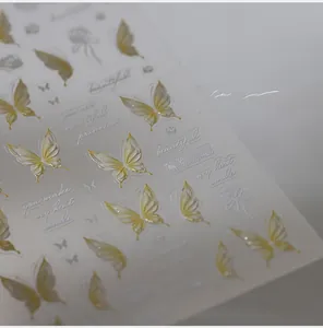 Macro shot of 3D embossed butterfly nail stickers with artistic English lettering