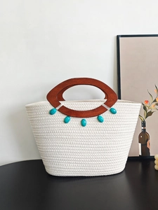 Large woven tote bag with brown wood handles and turquoise beads for women's beach vacation