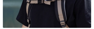 Detail of ergonomic 3D mesh shoulder straps and adjustable chest buckle on khaki backpack