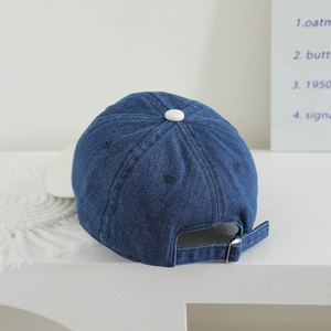 Kids denim baseball cap in dark blue with adjustable back strap and white top button