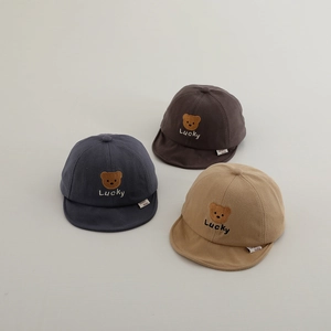Detailed embroidery of brown bear and Lucky text on soft cotton baby baseball caps