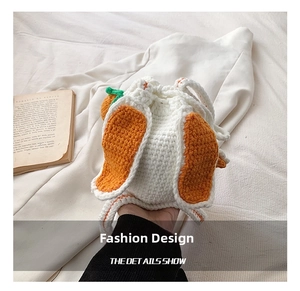 Close-up of handmade crochet bucket bag featuring rabbit ears and carrot design