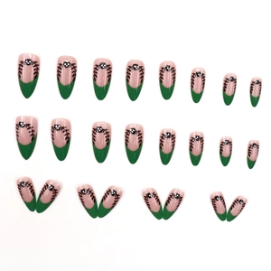French matte almond fake nails in deep green with black branch patterns and dots