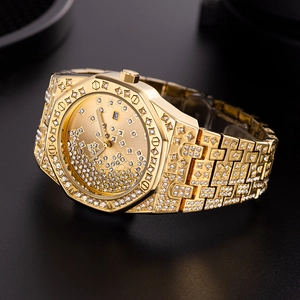 Close-up of gold iced-out watch with octagonal bezel and sparkling crystal details