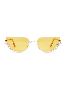 Detail of yellow cat-eye lenses and gold metal semi-rimless frame on y2k sunglasses