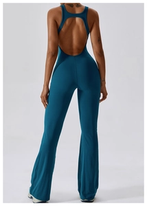 Detail view of the deep teal yoga jumpsuit featuring an open back and high waist bell bottom design