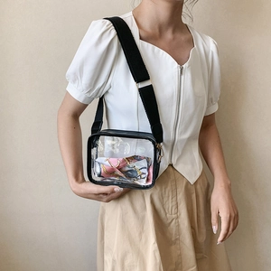 Transparent jelly crossbody bag with black trim and stylish pink silk scarf detail