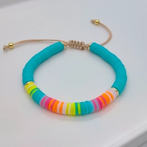 Macro detail of Bohemian colorful heishi bead bracelet with adjustable woven cord