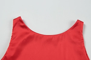 Close-up of red satin cocktail dress showing the smooth neckline and silk-like texture