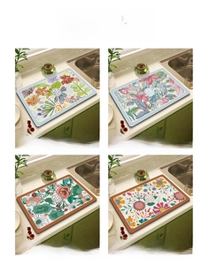 Detailed close-up showing four different floral patterns of absorbent kitchen draining mats