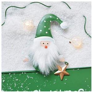 Close-up of a Christmas gnome ornament with green polka dot hat and golden star