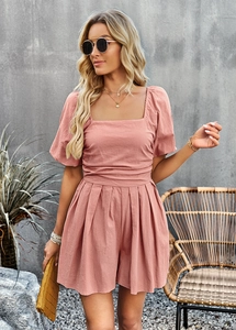 Detail view of pink square neck short jumpsuit with cotton-linen texture and summer accessories