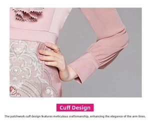Detail of pink dress featuring elegant floral embroidery and ruffled lace neckline