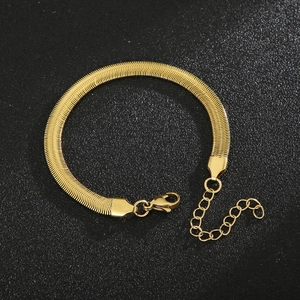 Detailed view of gold herringbone chain bracelet with lobster clasp and extender