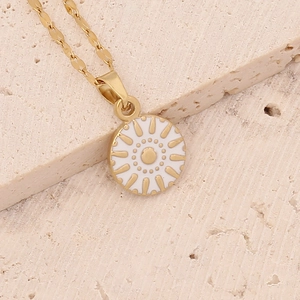 Detail of gold sunburst pendant with white enamel on a flat link stainless steel chain