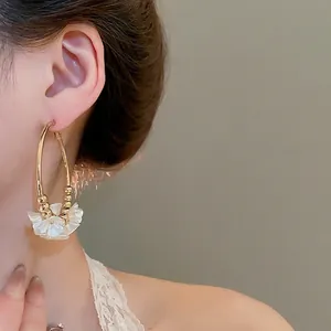 Elegant gold round hoop earrings with white acrylic flower pendant for women